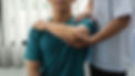 man-physiotherapist-assisting-male-patient-with-elbow-injury-clinic.jpg