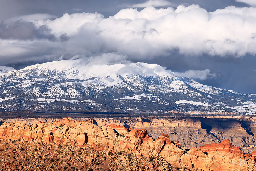 Winter storm clouds passing over snowcapped Mount Pennell in Capitol Reef National Park