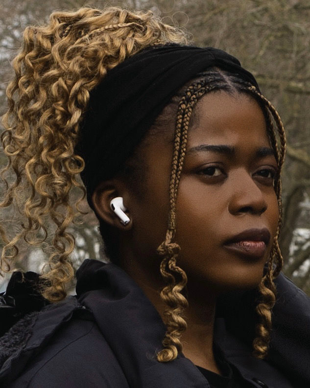 Urban Portrait of a Woman with Braids and Wireless Earbuds – Confident and Contemporary