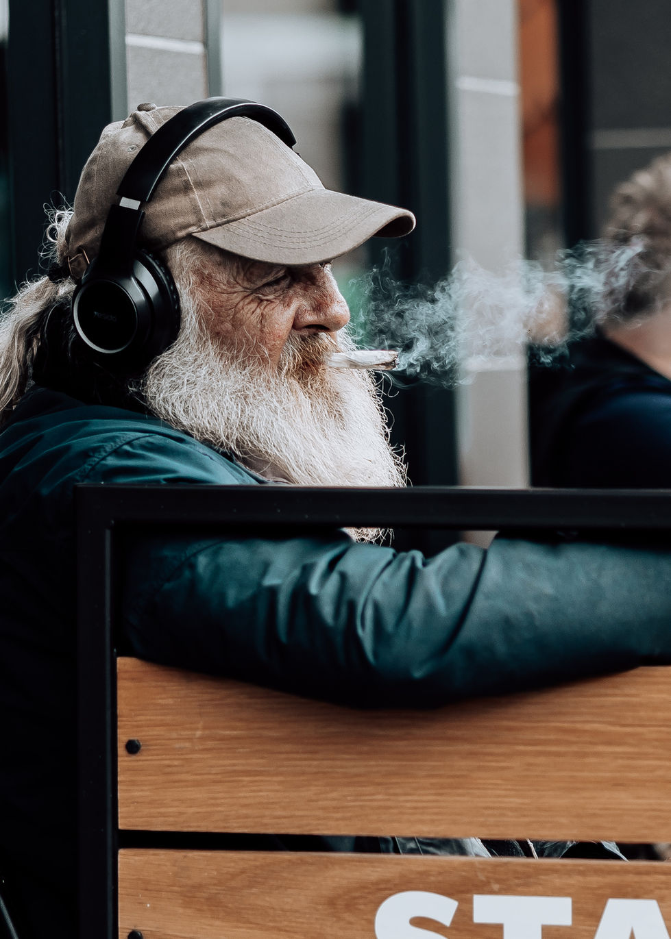 Candid Street Portrait of a Bearded Man in Headphones Smoking – Urban Character Study