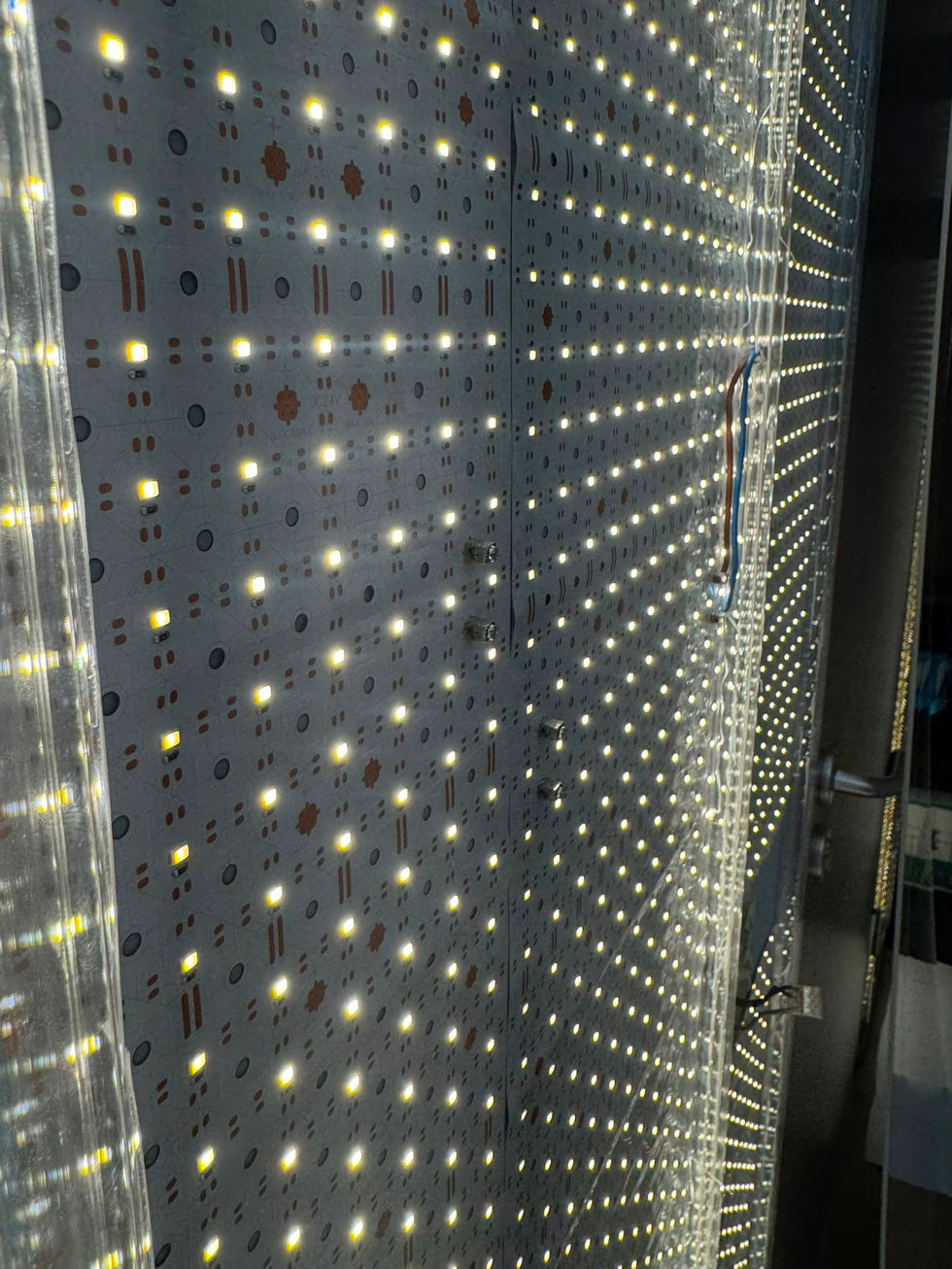 The LED sheets create an even backlight across the full wall surface.