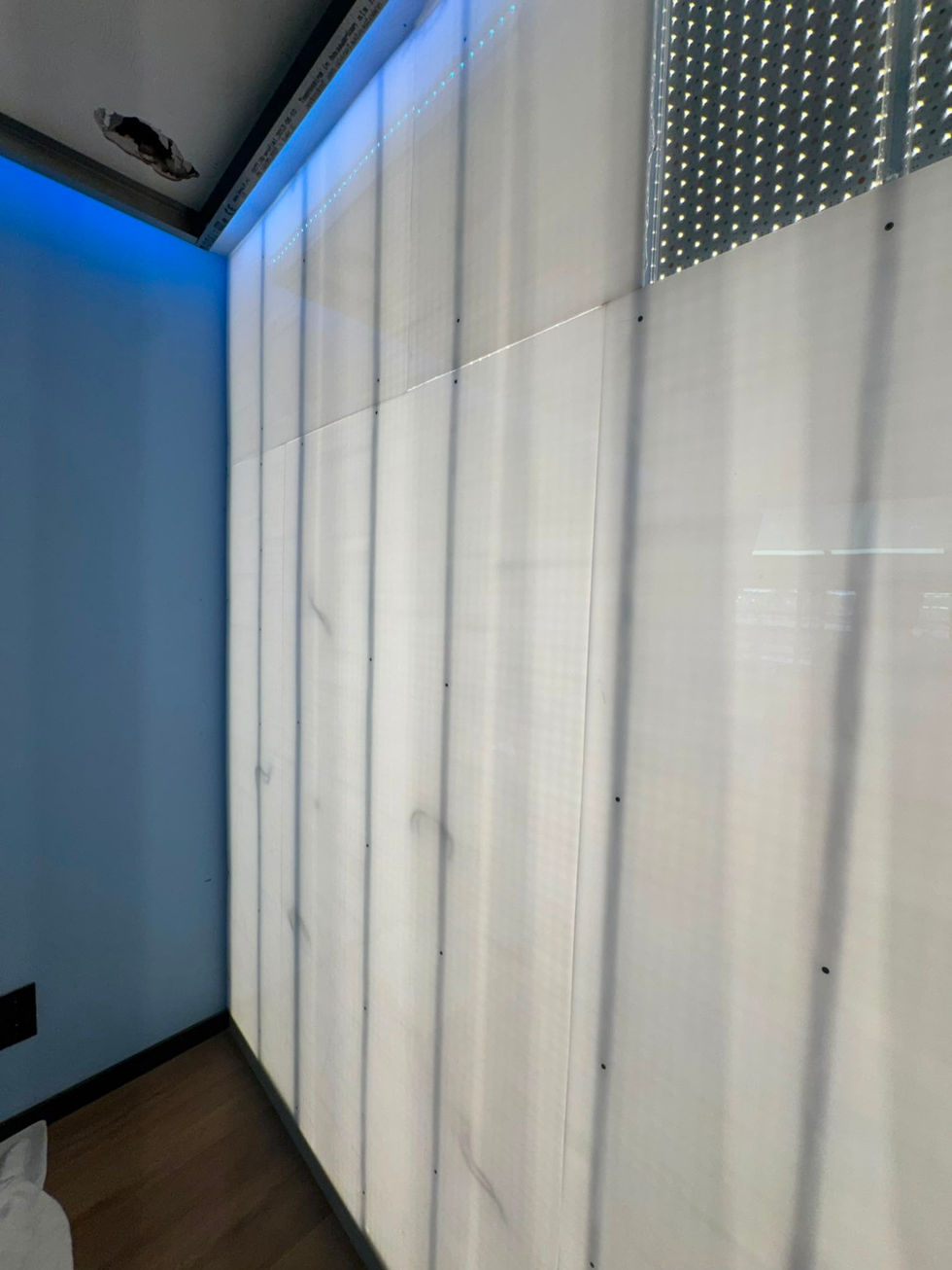 Custom LED sheets installed behind the feature wall.