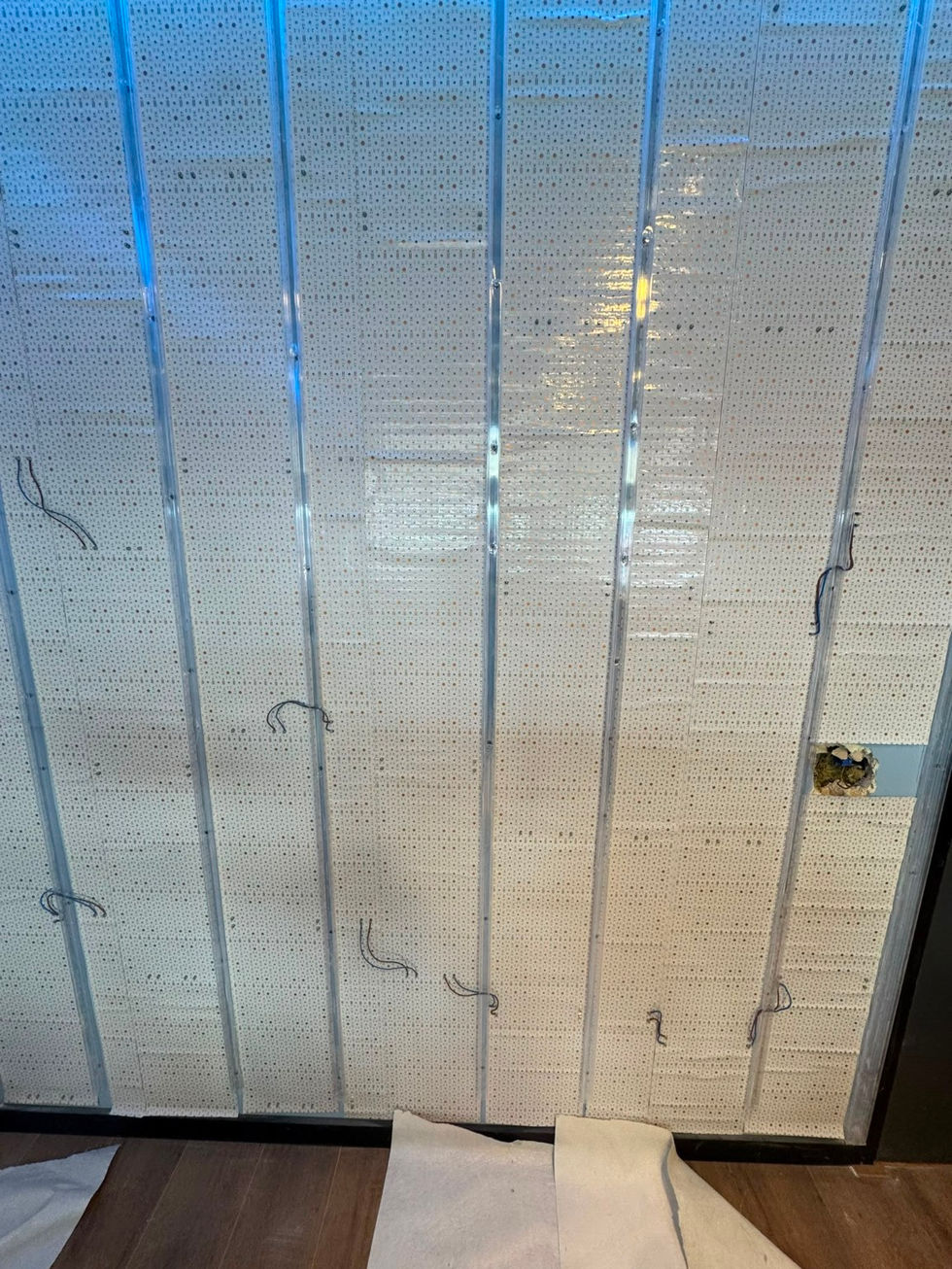 Custom LED sheets installed behind the feature wall.