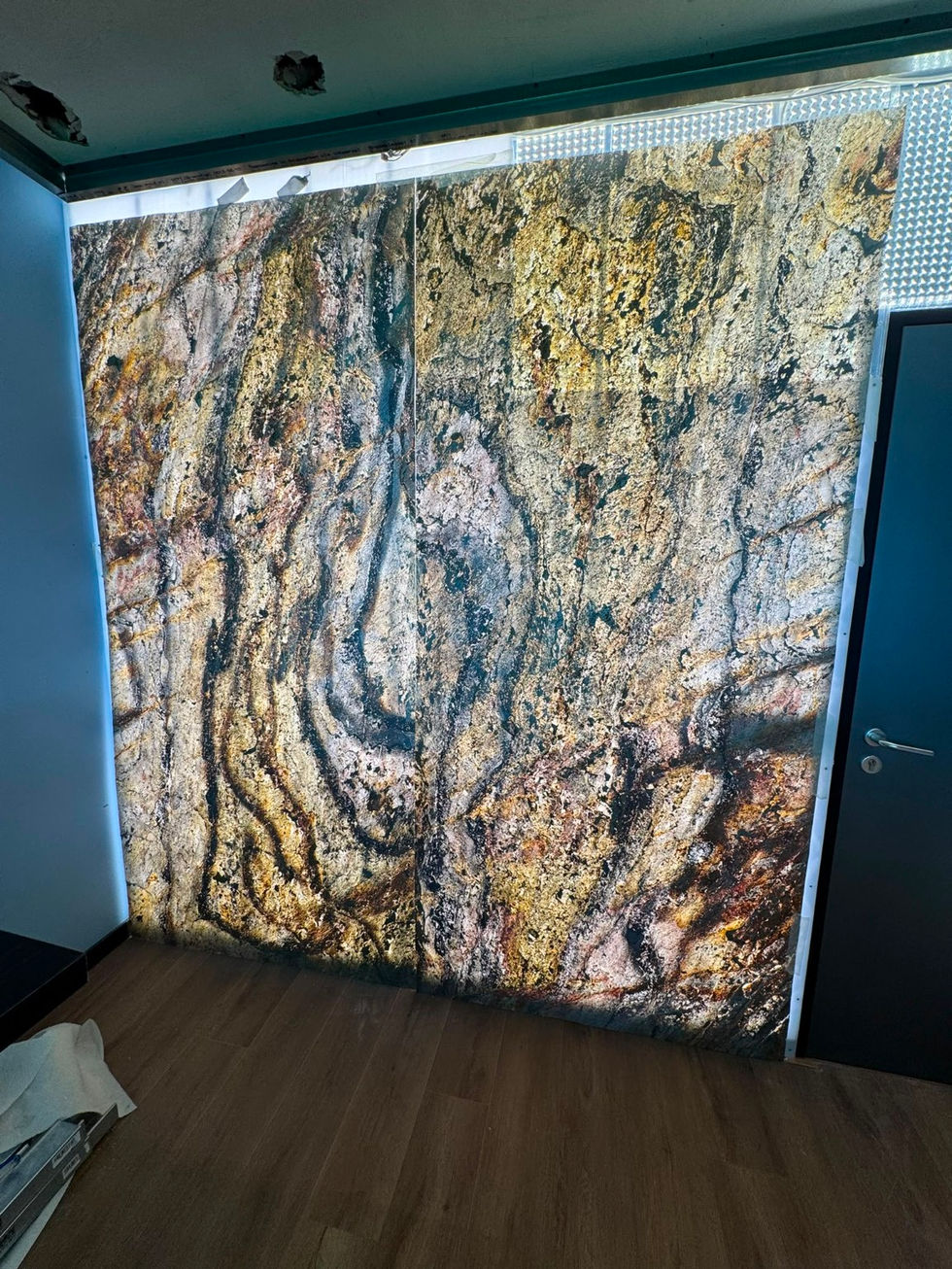 The marble-look panels are placed in front of the LED sheets.