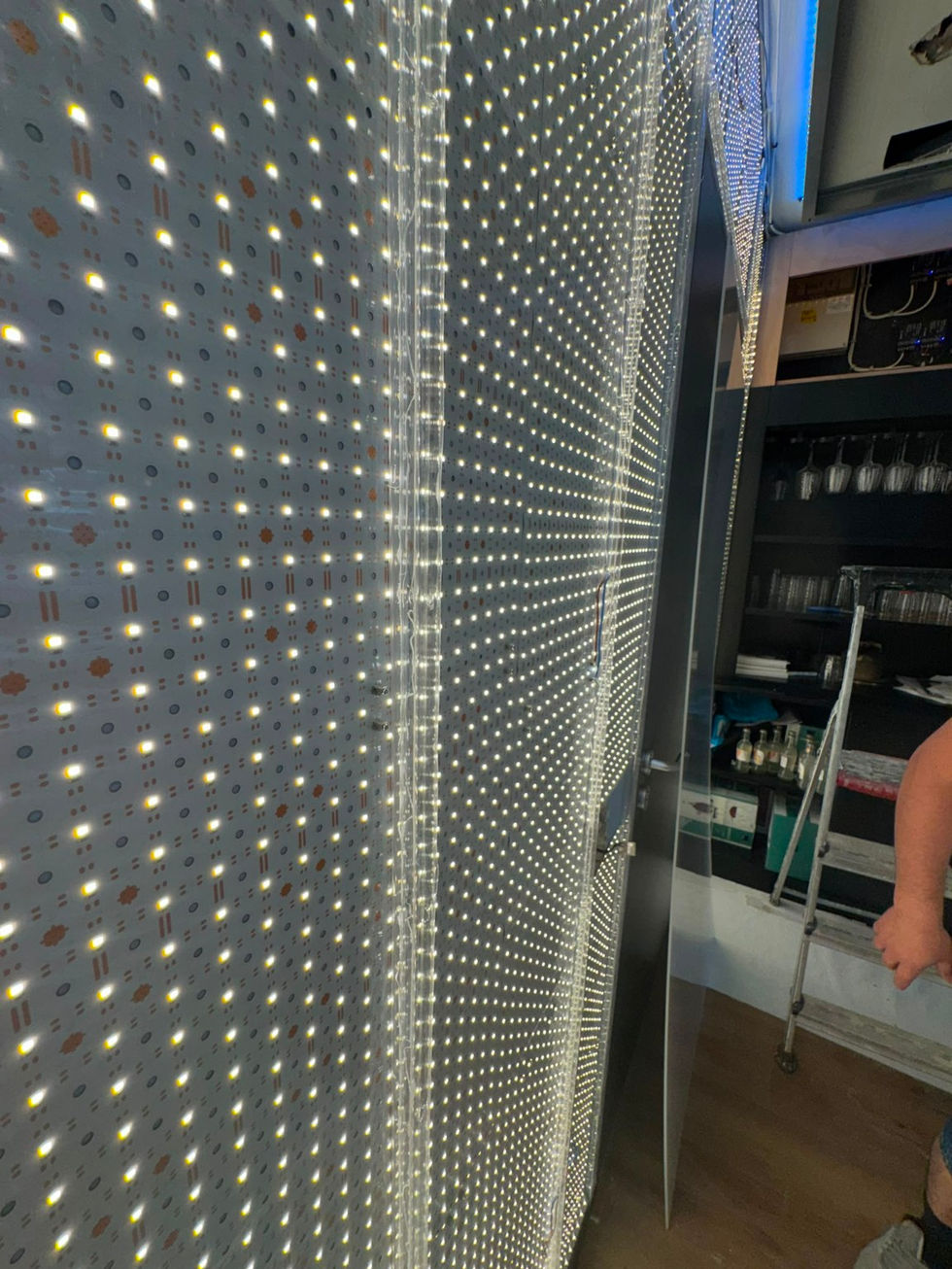 Custom LED sheets installed behind the feature wall.