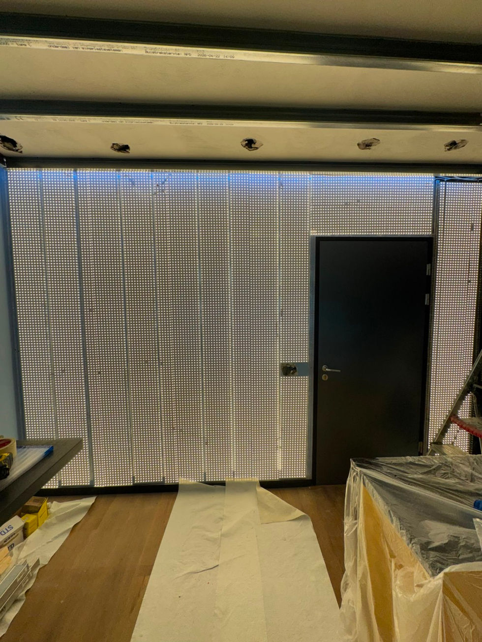 Custom LED sheets installed behind the feature wall.