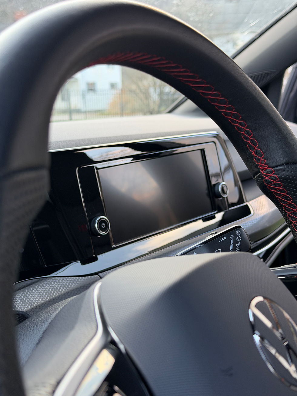 Car interior with steering wheel and infotainment screen