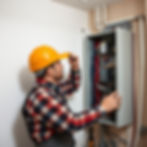 An electrician conducting an electrical inspection on a home's electrical system.jpg