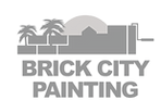A logo of a city skyline with the sun behind the buildings