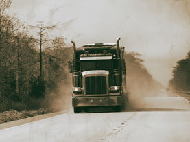 A commercial truck driving on an Arkansas road.