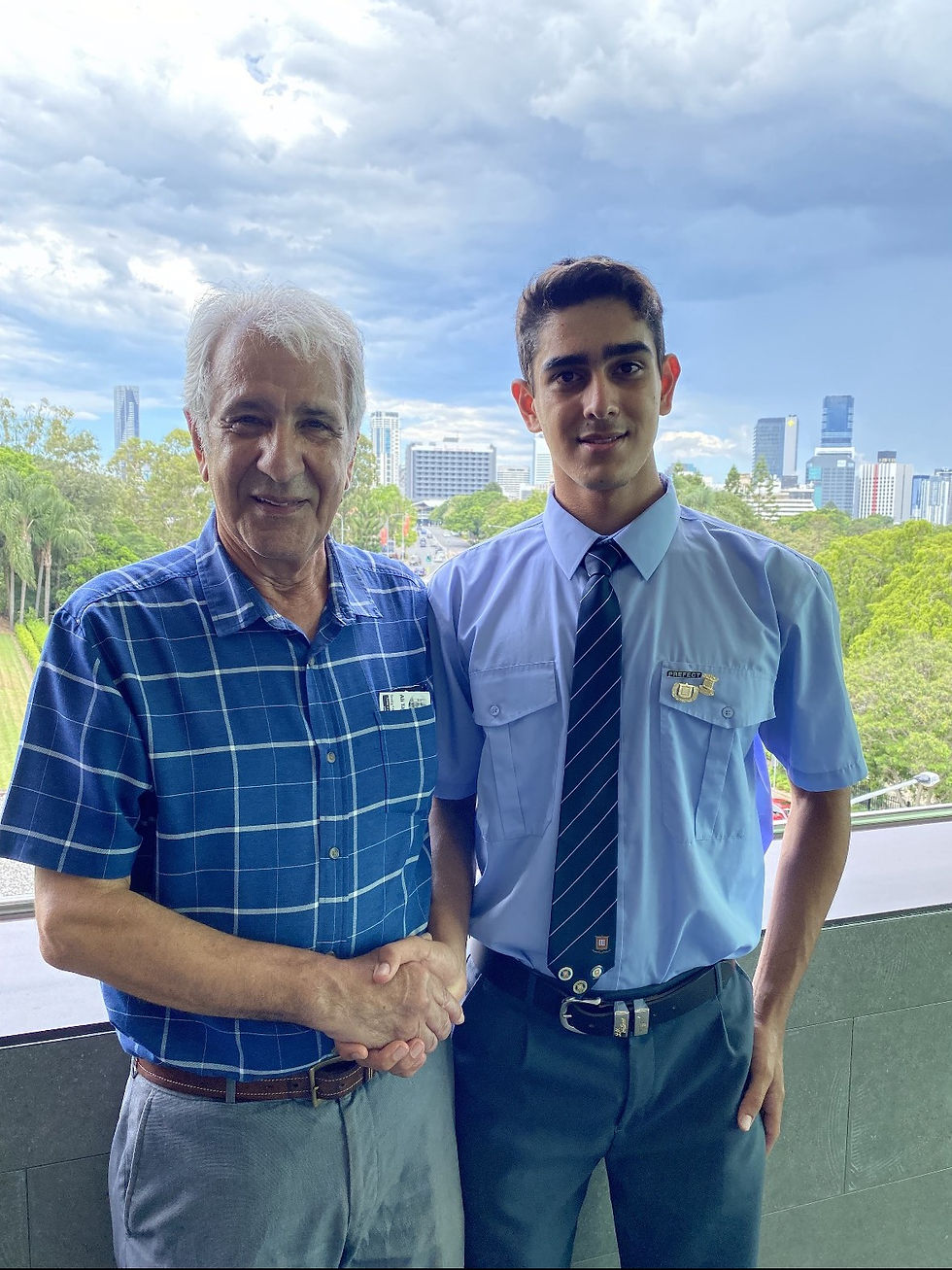 Ryan Khan with grandfather at Brisbane Grammar School, celebrating education and family support.