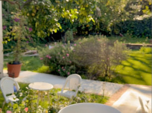 A hand cradling a pink floral coffee cup in a shaft of morning light, an everyday glimmer