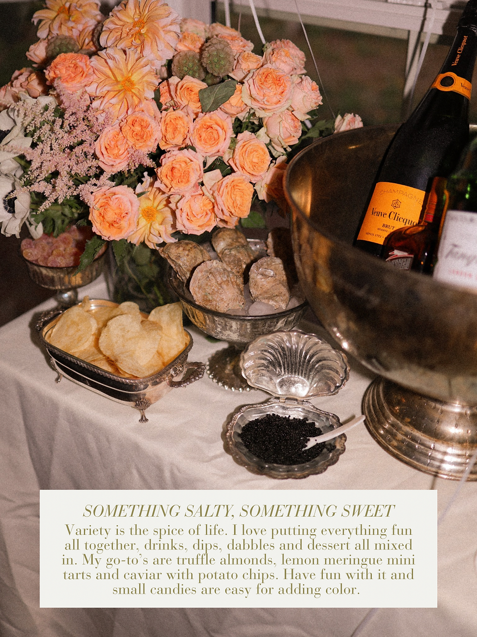 Silver shell dish with caviar, potato chips and Veuve Clicquot champagne on a maximalist party table with peach roses