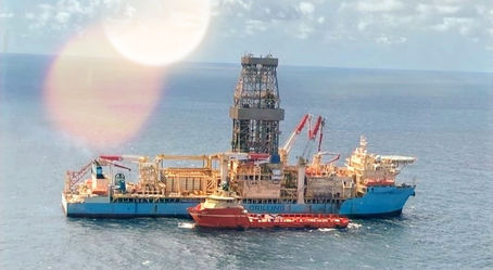 Drillship offshore with a supply vessel alongside, illustrating the South America contract announcement.
