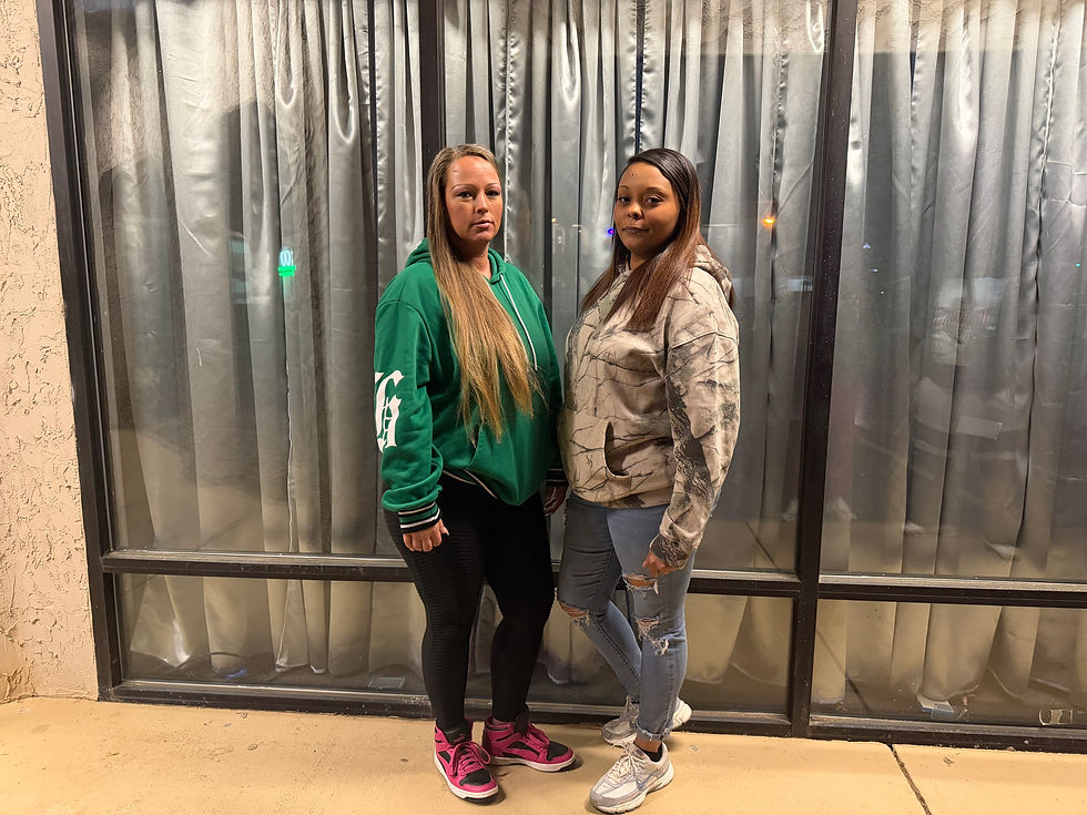 Lady Denee and Blaine Haynes pose in front of a storefront on March 29, 2026. Both Denee and Haynes are members of the online civilian-led safety group Street Sweeperz TV. (Photo/Isabella De La Sierra)