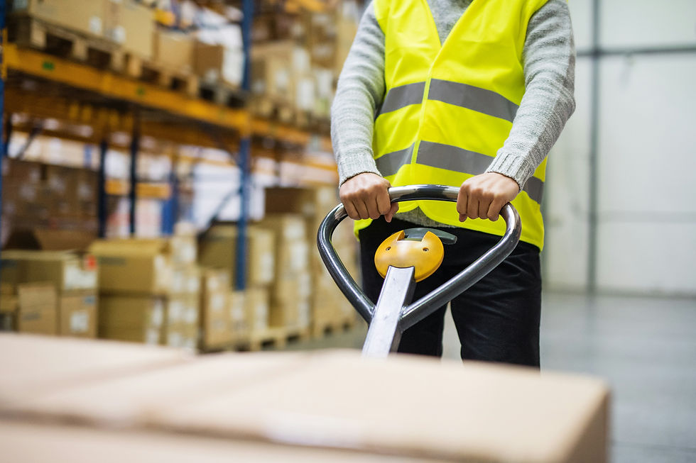 A person pulling a pallet in a warehouse