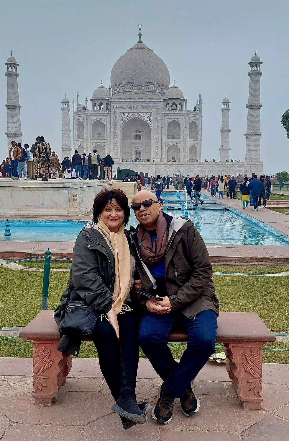 Vanessa and R8chard from Escape wlWith Us Blogs and Vlogs sitting in front of the Taj Mahal on the 'Princess Diana' seat.