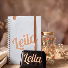 Personalised notebook with a name on the cover next to a gift jar