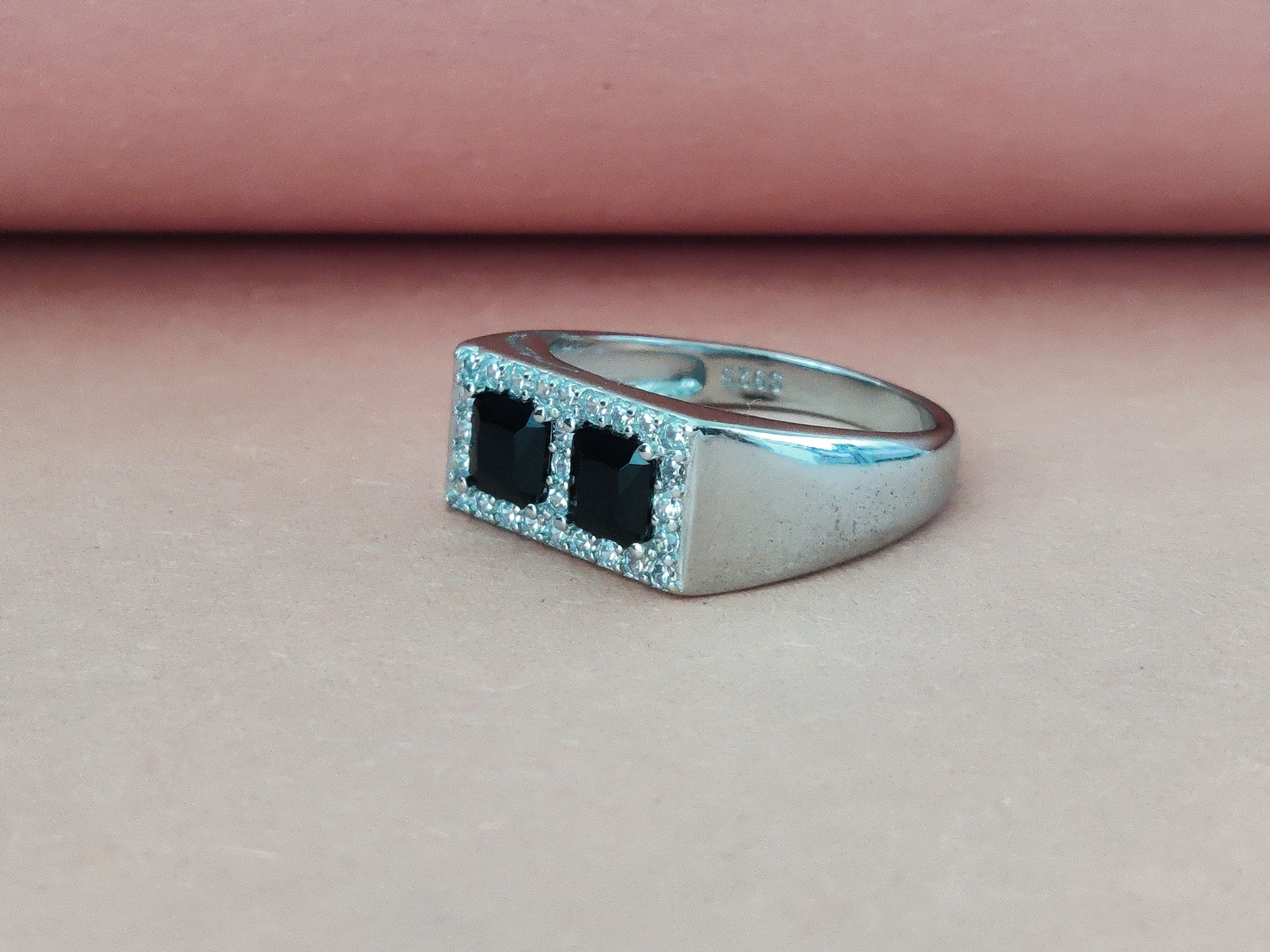 Two center-set square black stones with a high-polish finish