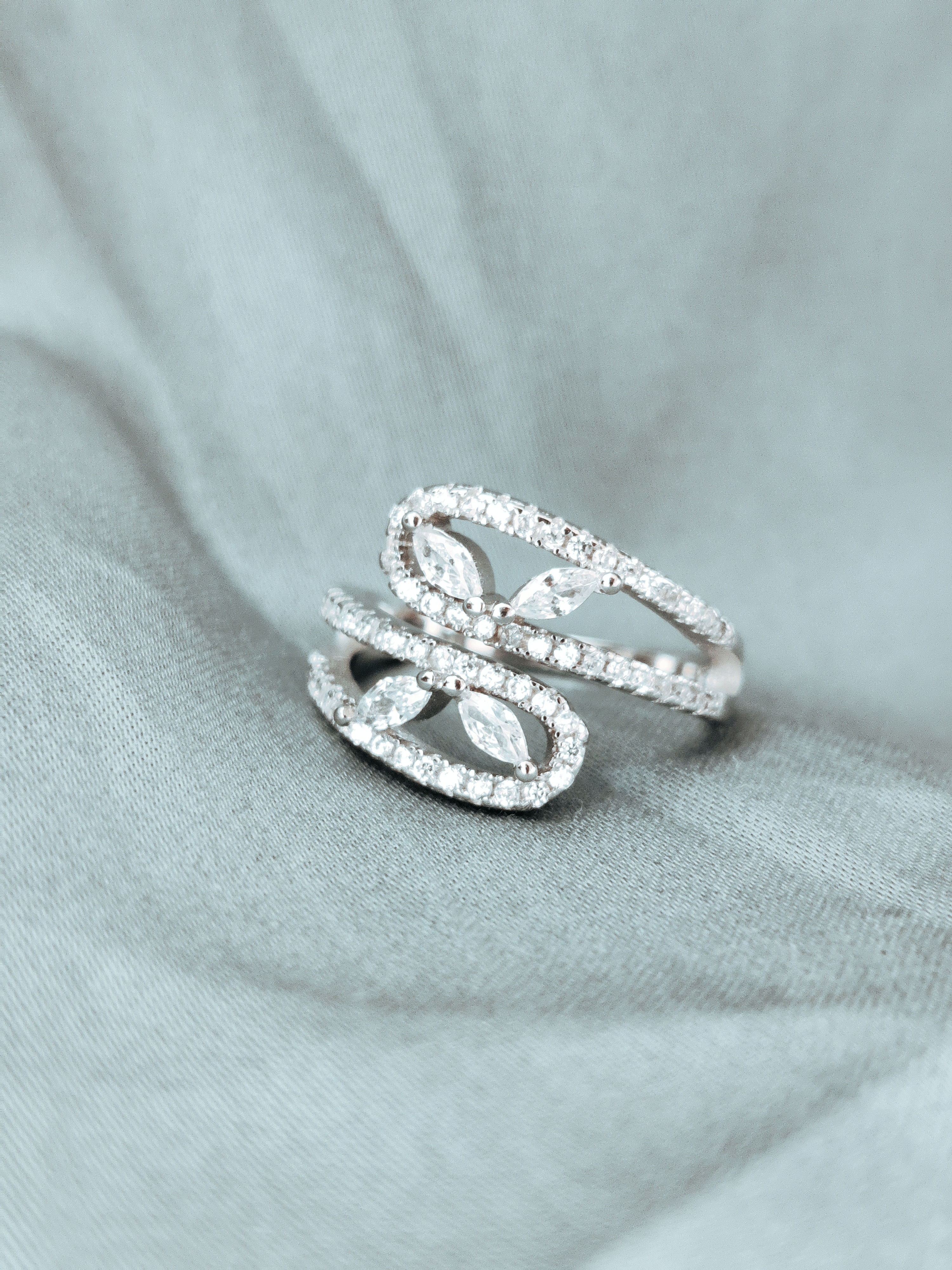 Features marquise-cut stones arranged in a delicate leaf pattern.