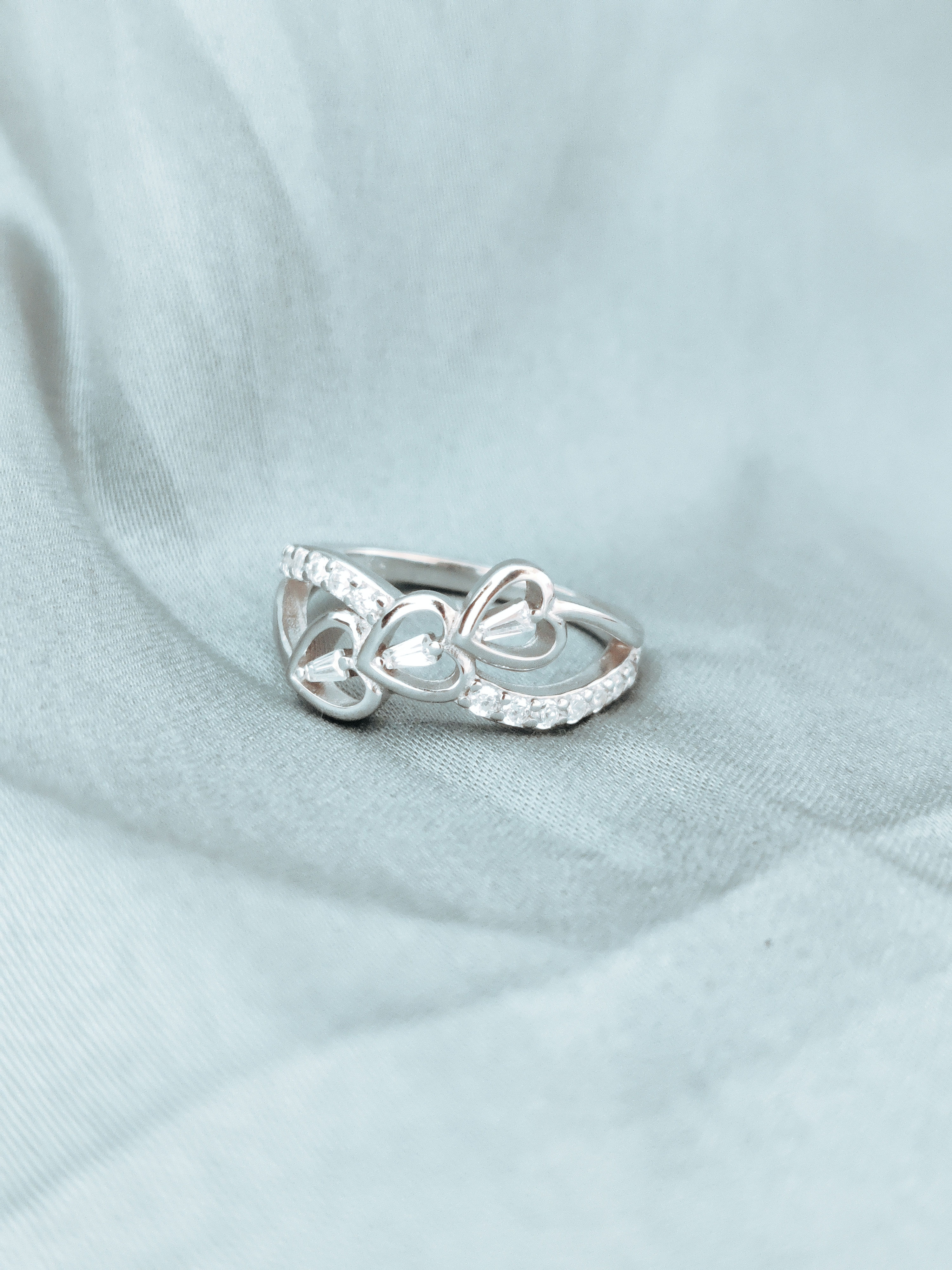 Elegant triple heart motif symbolizing love, unity, and connection.