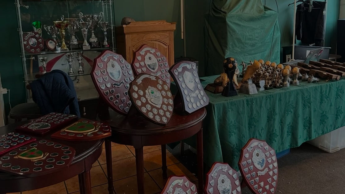 An image of a room filled with Sunday League trophies and plaques.