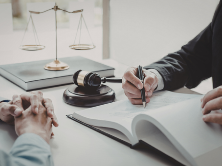 Georgia business owner reviewing divorce and business valuation documents with an attorney