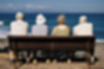 people on bench facing the sea shutterst