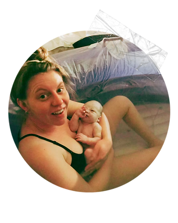 woman in birth pool holding newborn after home birth