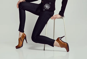 woman in black outfit wearing sagittarius emblems.png