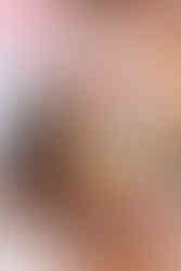 bride and groom with the pundit dropping rice into the holy fire