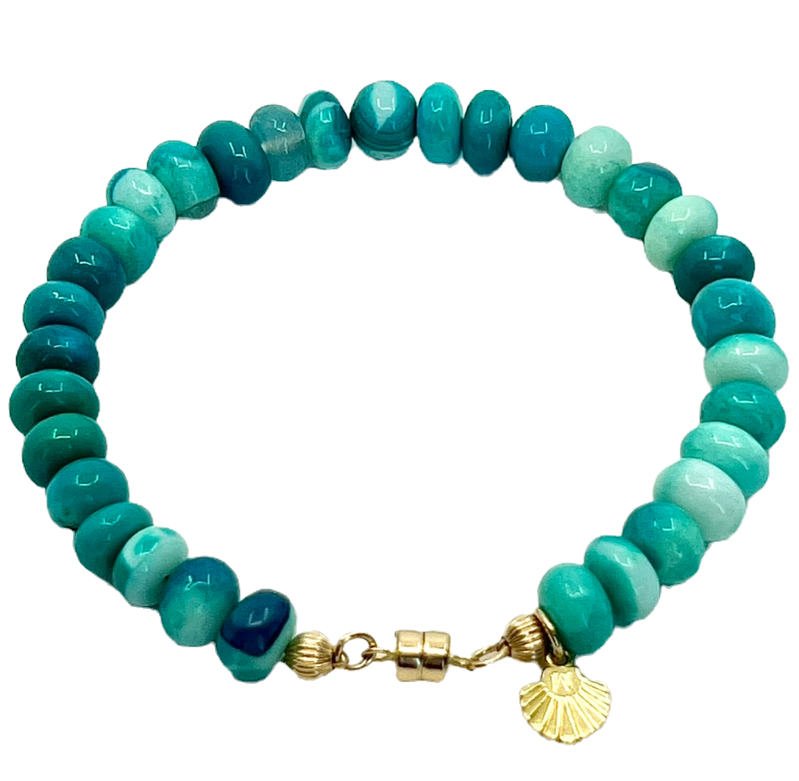 Turquoise beaded bracelet with a gold clasp and a sun charm on black background.