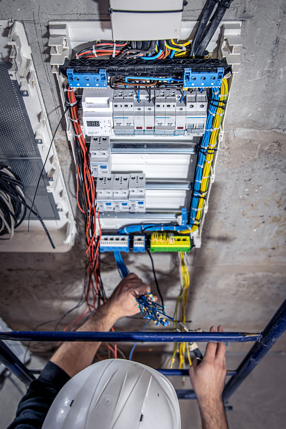 male-electrician-works-switchboard-with-electrical-connecting-cable.jpg