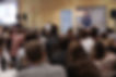A person presenting at an xChange event to a crowd of people