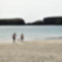 Two people walking along St Ninian's Beach, Shetland, heading for a refreshing cold plunge in the sea after a wild sauna experience at Haar Sauna, the UK's Best Nature Sauna.