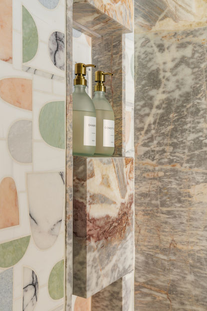 Stone shower niche in Terra Calma cabana bath designed by Firefinish Interiors.