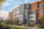 Modern row of newly renovated brick and siding townhouses beside a landscaped park with city skyline in the background