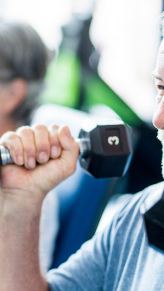 A man lifts weights to prevent osteoporosis