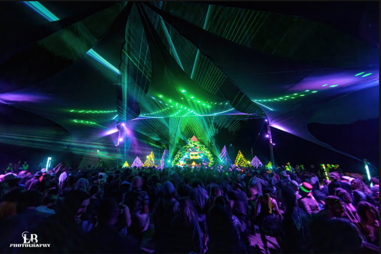 Dramatic picture of green lasers crossing with purple lights