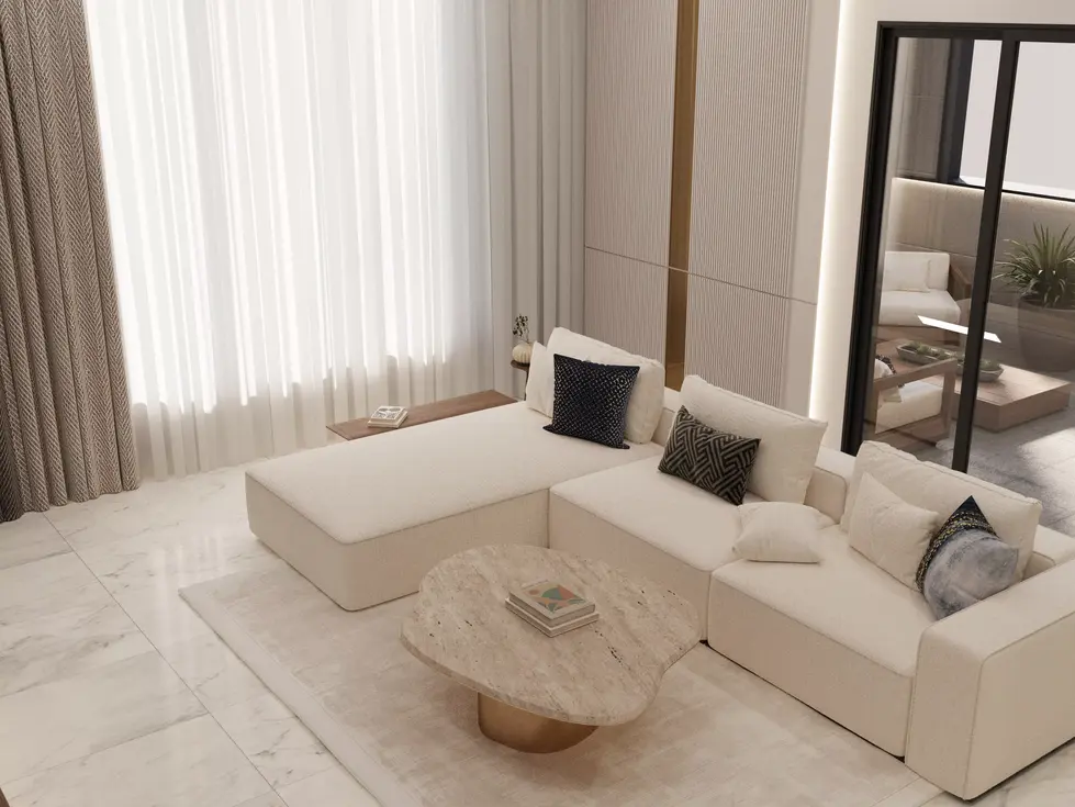 Minimal living room with white sofas, marble flooring, tall curtains, and a round stone coffee table in natural tones.