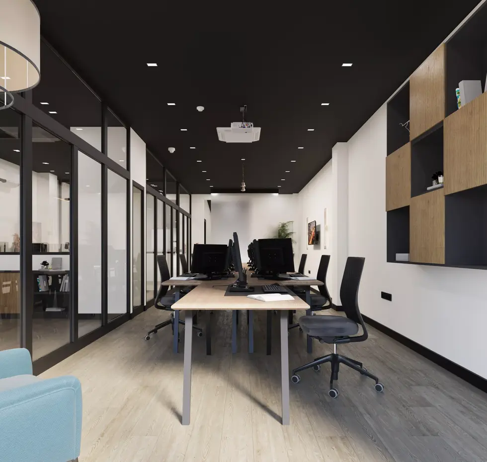 Bright open office with multiple monitors and black-white theme