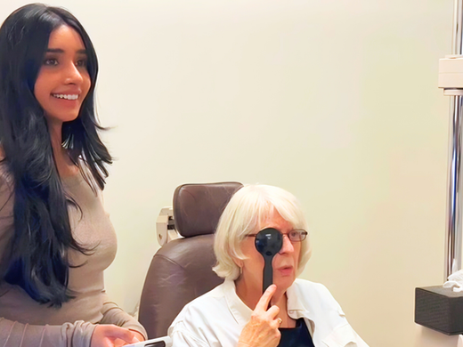 Dr. Leena Panaich working one-on-one with a low vision patient using MacuMira®, a specialized low vision device designed to help individuals with reduced vision perform everyday tasks more confidently.