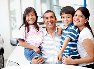 Hispanic family with two small children smiling at the camera