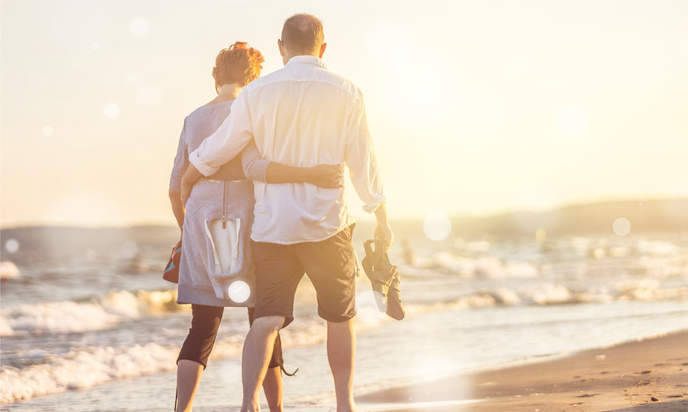 Retired couple walking on beach