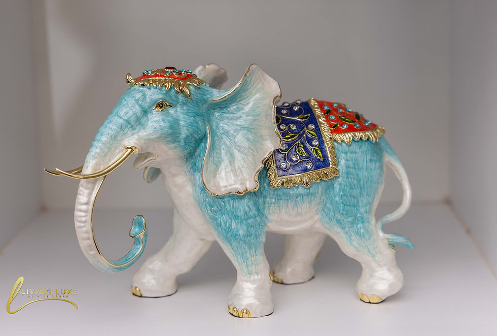 Multicolor Elephant Figurine Set - A decorative, light blue elephant figurine with a detailed, multicolored blanket and headdress, available at The Living Luxe in Karen.