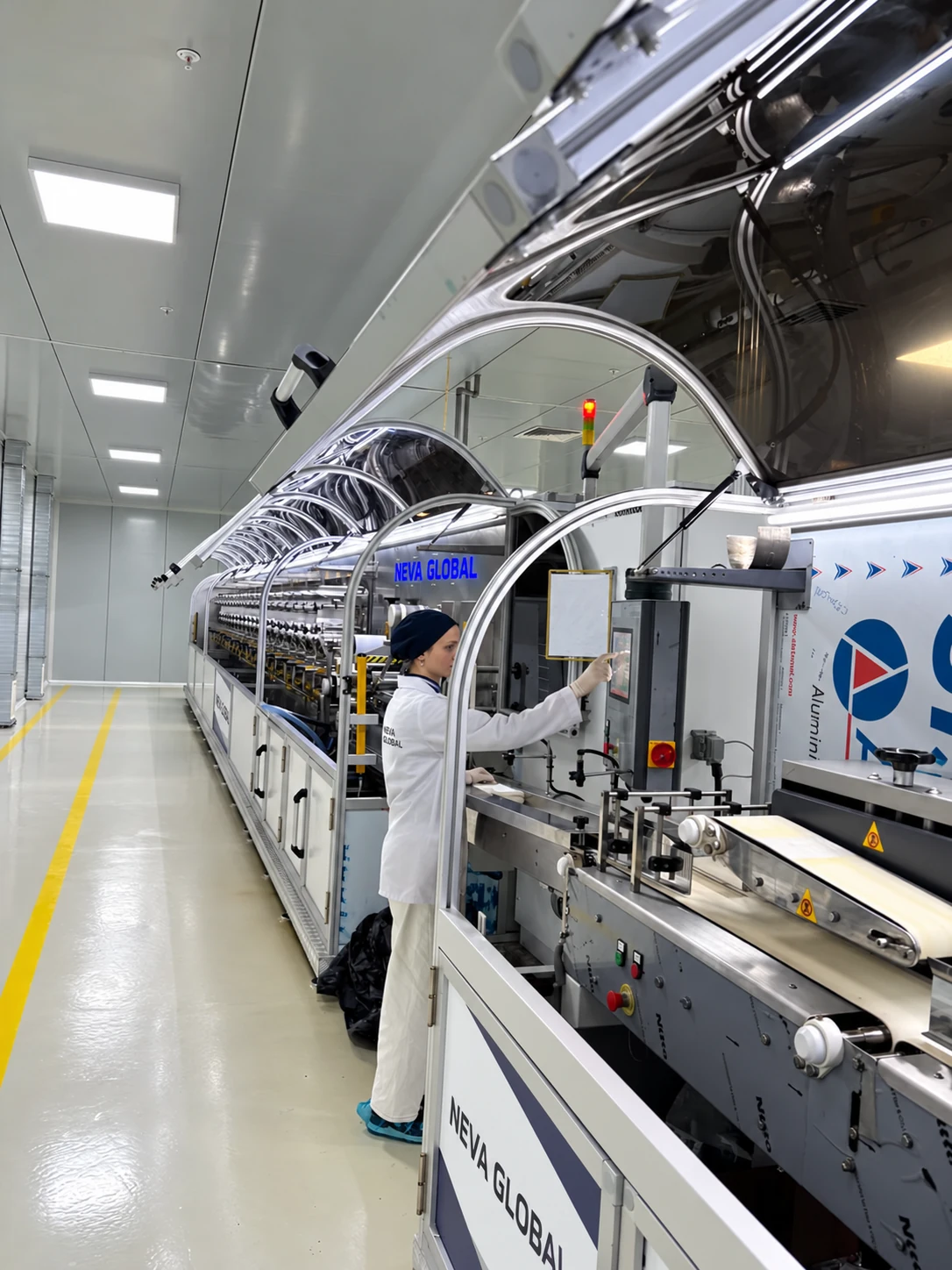 Neva Global production operator using the wet wipes manufacturing line control panel