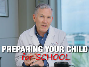Dr. Jason Lohr presenting a slide on preparing your child for school with measles vaccination