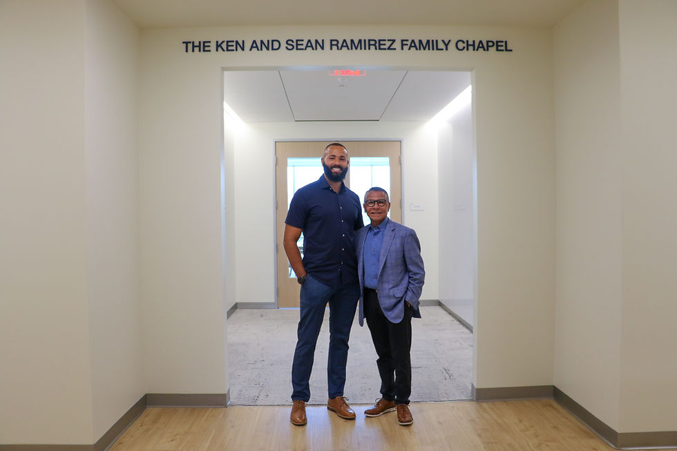Ken and Sean Ramirez pose in front of the Ken and Sean Ramirez Family Chapel at SAC Health Brier Campus