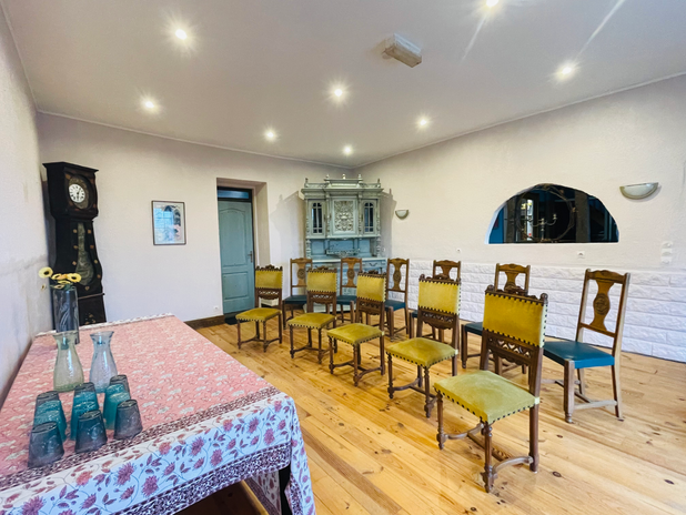 Large dining room laid out for a group lecture in French holiday townhouse