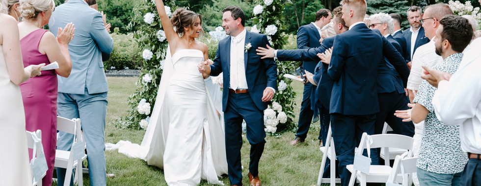 Bride and groom celebrate after getting married in Michigan backyard wedding